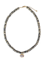 Load image into Gallery viewer, Dalmatian Glow necklace with spotted Dalmatian jasper stones and a clear oval crystal pendant