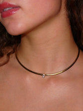 Load image into Gallery viewer, Élan Solo gold-tone stainless steel collar necklace with one clear marquise-cut cubic zirconia, modeled on the neck.
