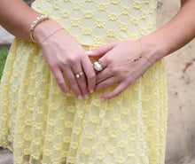 Load image into Gallery viewer, Bianca adjustable gold-plated stainless steel ring with a pearl accent and pear-cut clear crystal.
