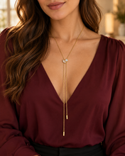 Load image into Gallery viewer, Model wearing the Solana adjustable gold-plated stainless steel lariat necklace with marquise and round clear cubic zirconia stones.
