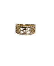 Load image into Gallery viewer, Close-up of a model styling the Valeria gold-plated crystal band ring with layered jewelry.
